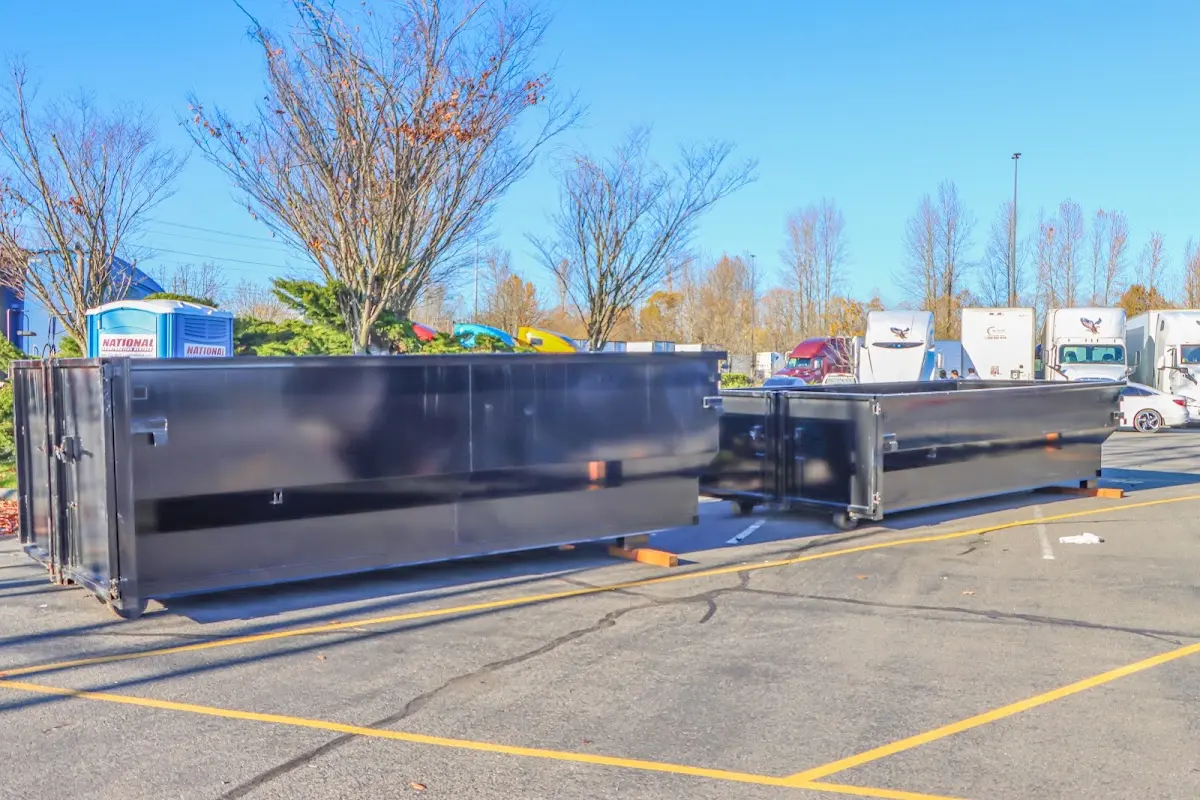 Professional dumpster rental service with roll-off container on residential driveway in Middlebury